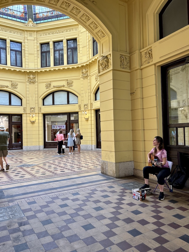 Interior of the historic Oktogon passage and musician in Zagreb