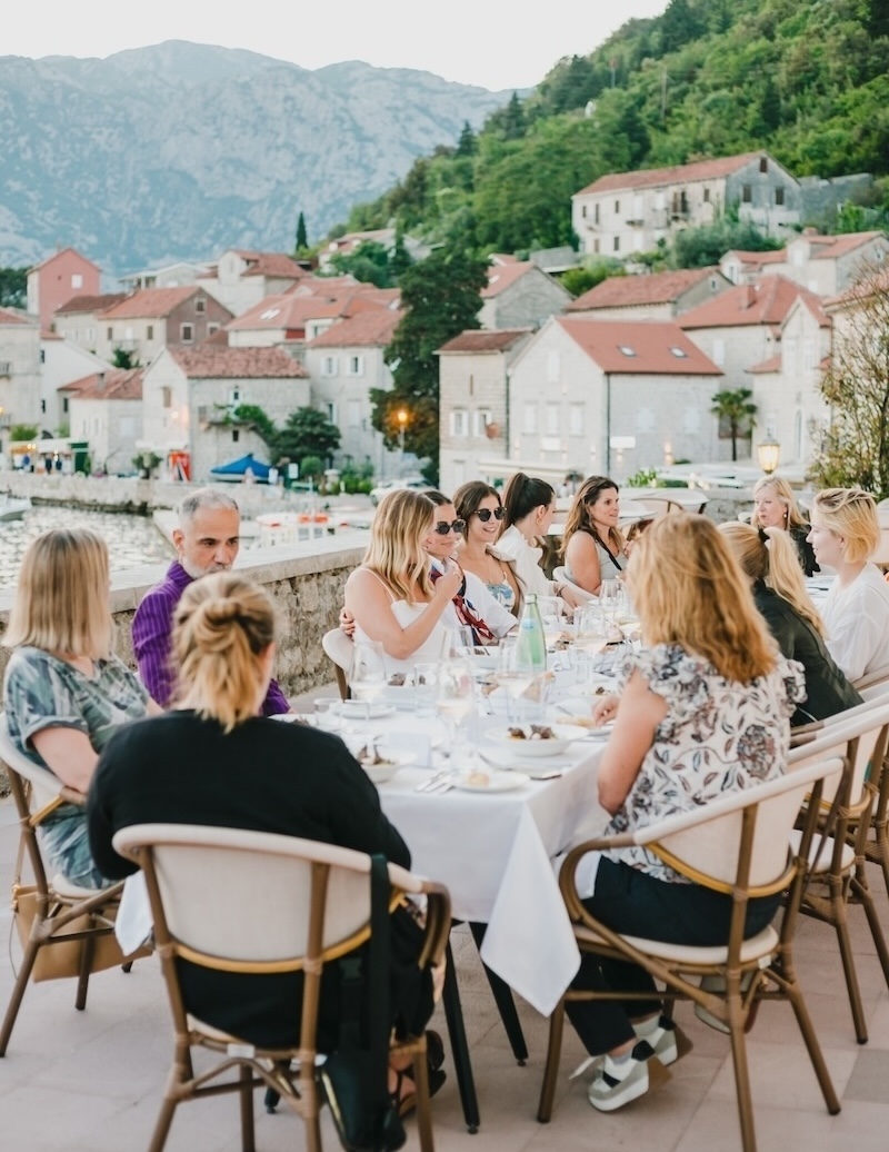 Friends and family gathered around a table in Montenegro